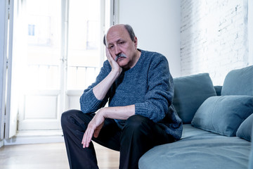 Depressed overwhelmed old man feeling exhausted alone and unhappy suffering from depression