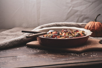 Grilled vegetables. Lenten menu. Appetizing eggplant, pepper, beetroot, tomato and patisson on plate. Fork, knife, napkin.Copy space