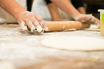 Young children make dough products. Hands closeup