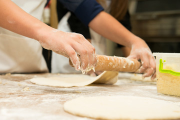 Young children make dough products. Hands closeup