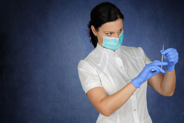 Girl nurse cosmetologist in mask holding syringe for injection.