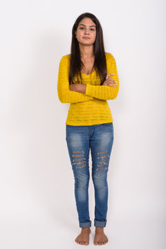 Full Body Shot Of Young Indian Woman Standing With Arms Crossed 