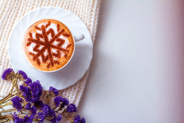 Obraz na płótnie Canvas Cappuccino with a pattern of snowflakes as