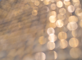Fototapeta premium Abstract gold bokeh background, metal surface is not in focus