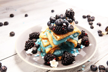 Delicious Tasty Homemade crepes or pancakes with blackberries,blueberries and blue spirulina nicecream.