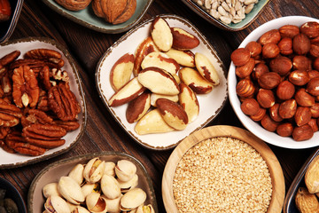 nuts composition on rustic table with walnut and peanut.