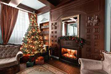 Christmas morning. Gifts at the Christmas tree. Classic apartments with a fireplace. Room with shelves of books