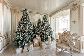 Christmas morning. classic luxurious apartments with decorated christmas tree. Living hall large mirror, chair, high windows, columns and stucco.