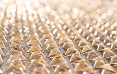 Fototapeta premium Abstract gold bokeh background, metal surface is not in focus