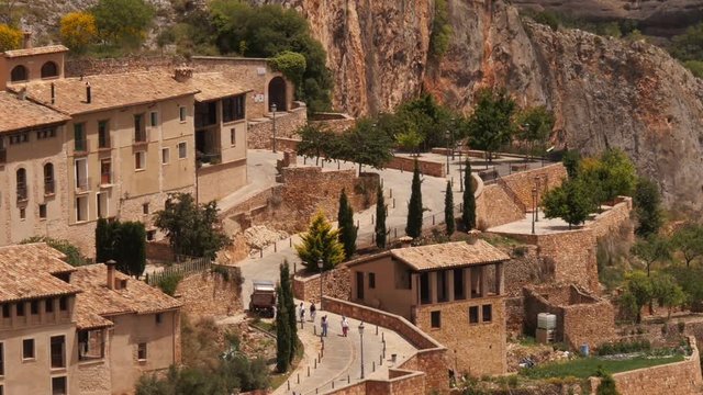 Tourists walking through the medieval village of Alqu&eacute;zar, Huesca Aragon, Spain &ndash; shot from above.