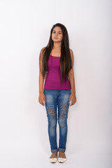 Full body shot of young Indian woman standing while wearing slee