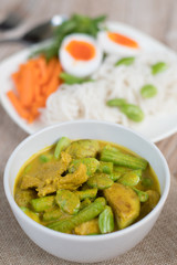Thai food spicy pork and vegetable Parkia speciosa curry in coconut milk and Thai rice flour noodles
