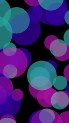 Multicolored translucent circles on a dark background. Vertical image orientation. 3D illustration