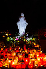 Bratislava, Slovakia. 2017/11/3. A statue of the Most Sacred Heart of Jesus at Martinsky cintorin (cemetery)  during the All Souls Octave. Kindling candles are in front of it.