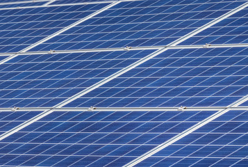 Close up rows array of solar cells or photovoltaics in solar power station convert light energy from the sun into electricity alternative renewable clean energy from the sun