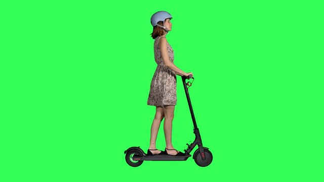 Casual looking young woman riding an electric scooter , looking around and waving hello, wearing a helmet, over a green screen,
