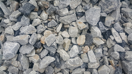 Large and small piles of limestone for use in lime kiln line  . Limestone gravel background Texture.