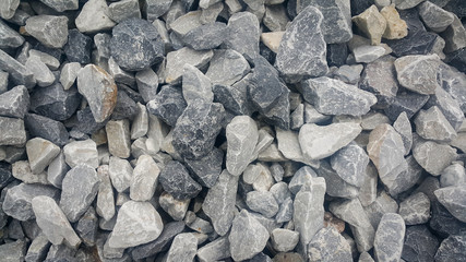 Large and small piles of limestone for use in lime kiln line  . Limestone gravel background Texture.