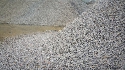 Small piles of limestone for use in lime kiln line  . Limestone gravel background Texture.