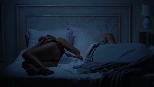Couple in bed having fight for too small blanket, uncomfortable bedding