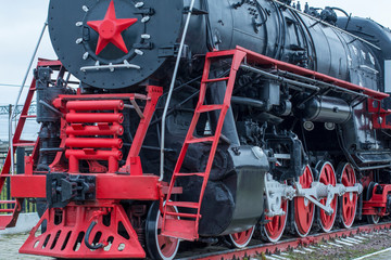 big steam locomotive with a red star, wheels of old steam locomotives. a pair of wheels. retro locomotives. vintage