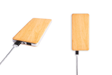 Power bank, Charger connector, Wood pattern. Charger is connected.