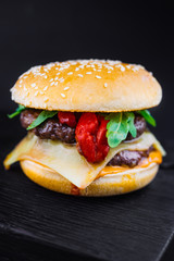 Homemade burger with grilled beef meatball, burger on a black backgroud, Craft beef burger, fresh tasty burger