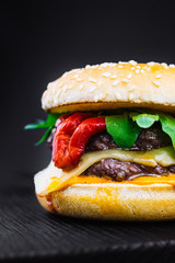 Homemade burger with grilled beef meatball, burger on a black backgroud, Craft beef burger, fresh tasty burger