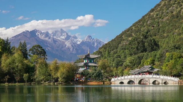Jade Dragon Snow Mountain and the Suocui Bridge over the Black Dragon Pool in the Jade Spring Park, Lijiang, Yunnan province, China.