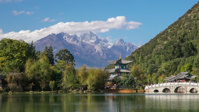 Jade Dragon Snow Mountain and the Suocui Bridge over the Black Dragon Pool in the Jade Spring Park, Lijiang, Yunnan province, China.