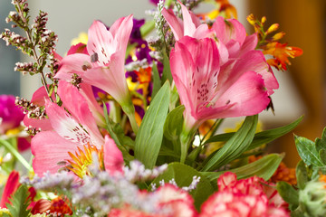 Close-up of beautiful pink lily flowers in an indoor floral arrangement