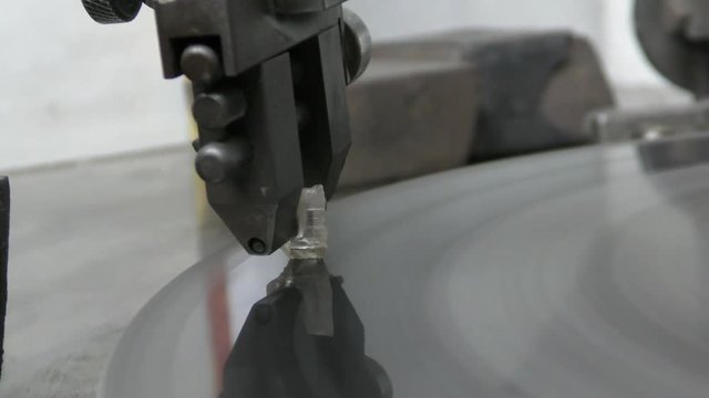 A diamond held by dop is polished on rotating automatic cast iron lap
