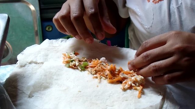 Wrapping up various vegetable lumpia rolls sorties in a dirty kitchen