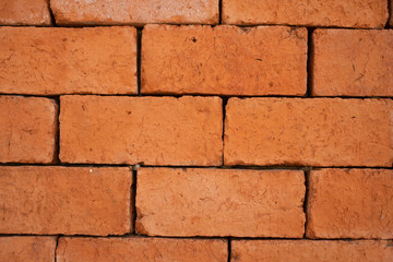 Old grunge orange brick background.
