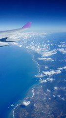 Blue sky and beautiful sea from the top of the plane.