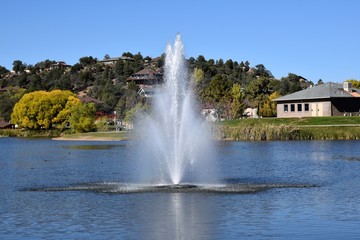 Water fountain in a lake at a city park 