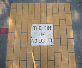 Painted brick with words on sidewalk 