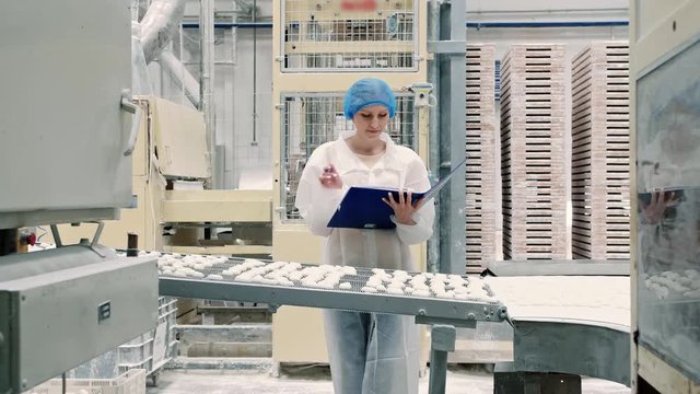 Controller checking conveyor with candies. Candy factory.