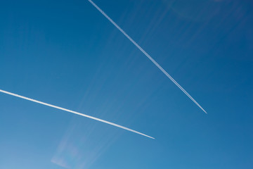 Two planes with traces on a blue sky background.