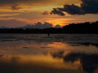 silhouette sunset on a beautiful Krabi Thailand beach. gold color sky sunset soft smooth sand beach.