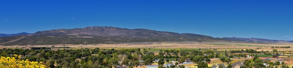 View of Kanarraville valley and mountain range from hiking trail to Waterfalls in Kanarra Creek Canyon by Zion National Park, Utah, USA.