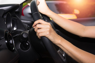 Hands of driver in a car