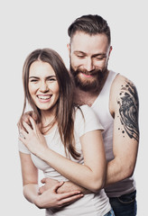 Happy couple embracing and looking camera on white background