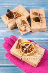 Hand of woman in gloves with decorated gifts for Christmas