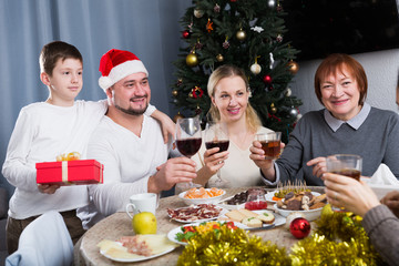 Fototapeta na wymiar Family at dining table for Christmas dinner