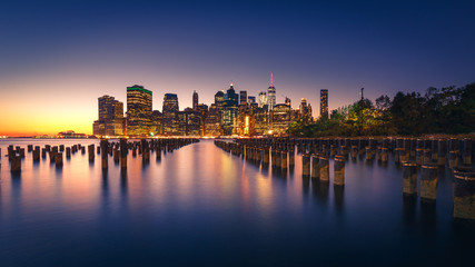 Illuminated Manhattan skyline with reflections. New York City