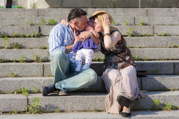 couple with a baby on a sunny day