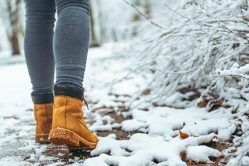 woman winter boots on snow close up