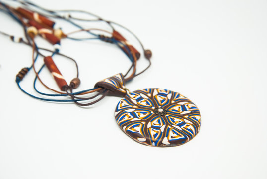 Mandala ethnic pendant isolated. Handmade jewelry of polymer clay. Winter necklace.