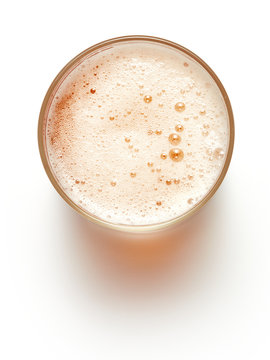 top view of glass of beer with forth isolated on white background